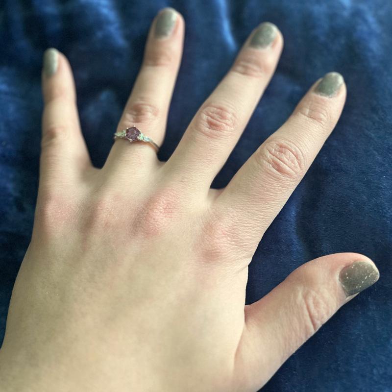 A photograph of Erin's hand with a new wedding ring on her ring finger